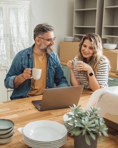 couple relaxing surrounded by moving boxes